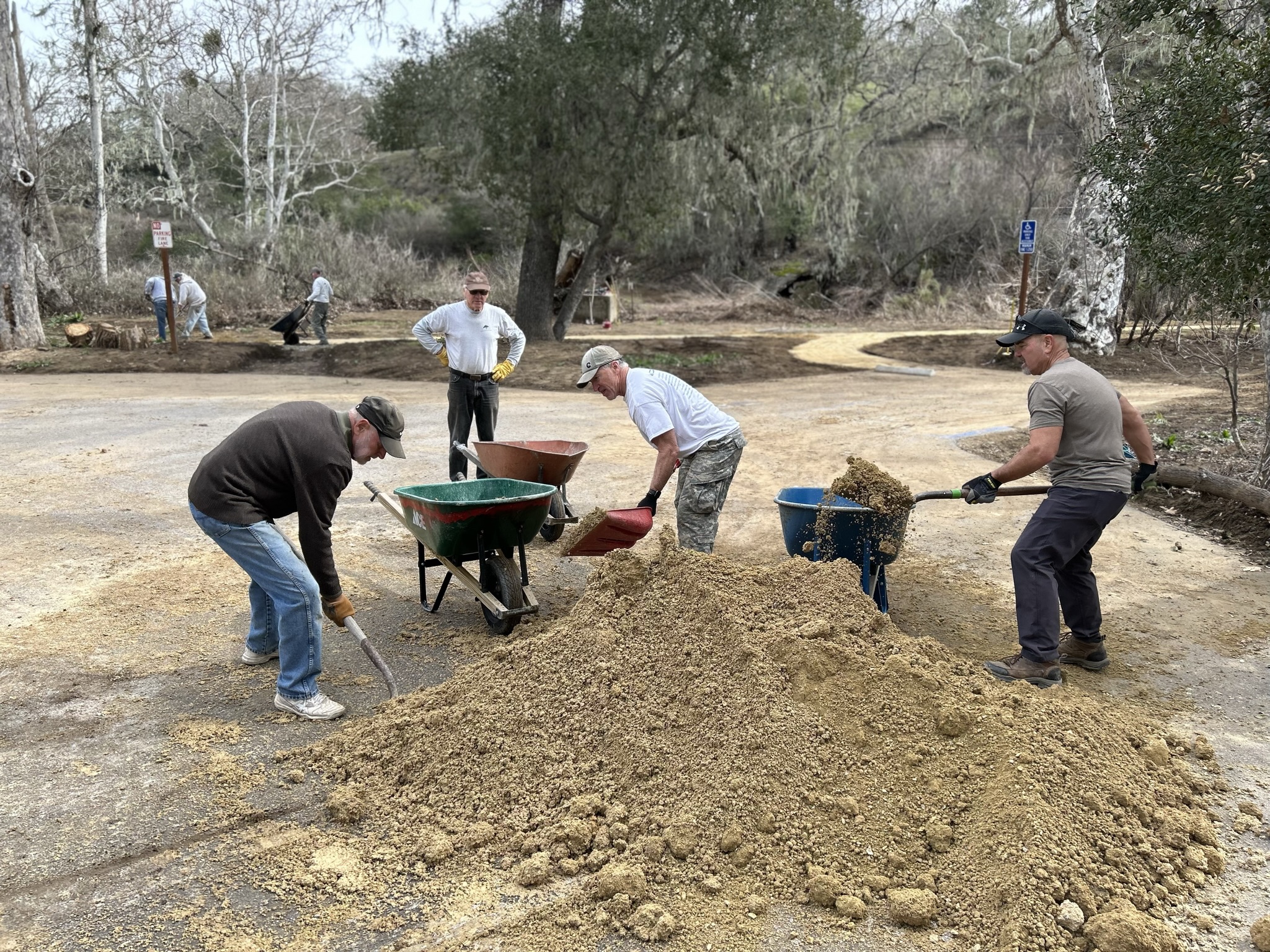 Loading DG in wheelbarrows to put on the path